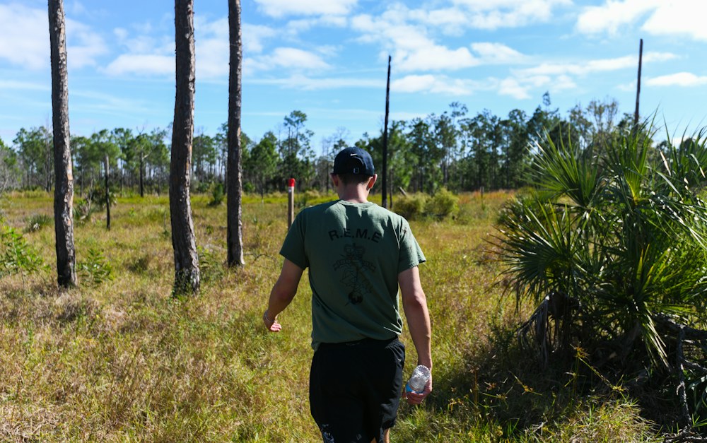 Person walking through a green South Florida landscape